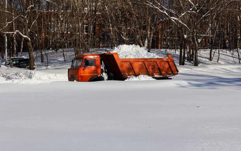 A dump truck transports the removed snow.