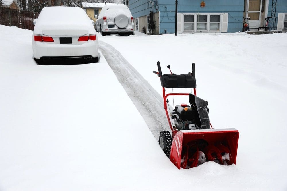 removing snow with snowblower