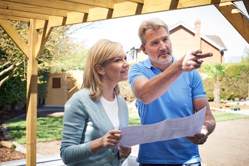 Mature Woman Discussing Plan With Landscape Gardener